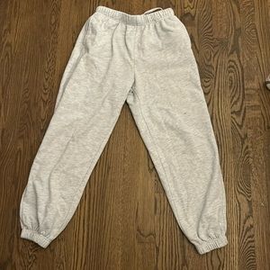 The brand is Garage, and the color is a light grey. Baggy fit.